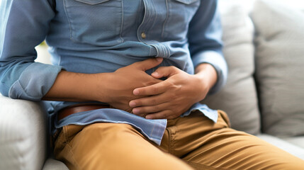 Gastroenterologist examining patient with stomach pain on couch in clinic, closeup