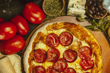 Delectable Pepperoni Pizza Surrounded by Fresh Ingredients