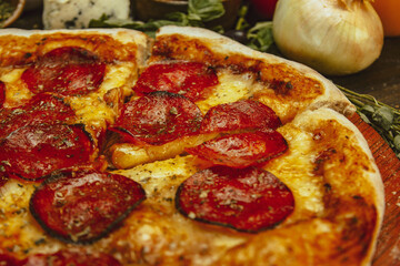 Delectable Pepperoni Pizza Surrounded by Fresh Ingredients