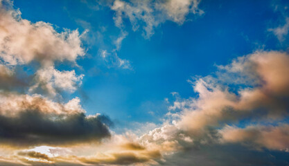 Blue sky clouds background. Beautiful landscape with clouds and orange sun on sky