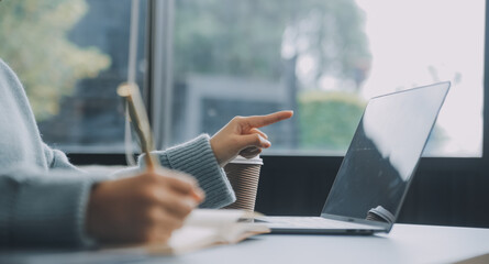 Confident female interpreter translate document from foreign language to english use pc app make notes in paper copy. Professional young woman editor correct errors mistakes in printed article text