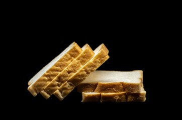 Closeup of Bread Pieces Stack Isolated on Black Background with Copy Space