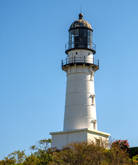 Low angle view of a New England Lighthouse against a  clear blue skyNew England