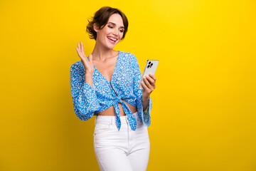 Photo of shiny friendly young woman wear flower print blouse video call modern device empty space...