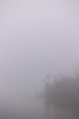 View of the river in the fog. Island in the fog.