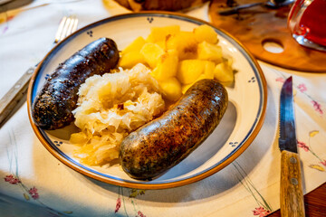 Baked white and black pudding (sausage) with cabbage boiled potato. - 736428091