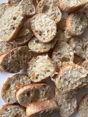Baked sliced baguette drizzle with olive oil topped with parmigiano reggiano cheese