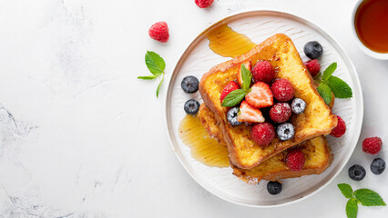 French toast with fresh berries and syrup on white background, panoramic shot with copy space