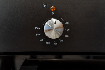 a close up of a knob on a black appliance