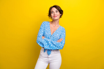 Photo of dreamy adorable young woman wear flower print blouse arms folded looking empty space...