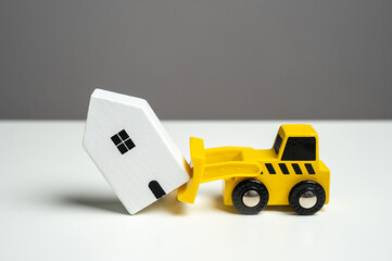 Demolition of a house with a bulldozer. The bulldozer intends to demolish the house. Making way for...