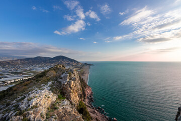Panoramic view of the countryside and the Mediterranean coast, view from the mountain to a landscape with clouds and sea.