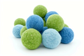 Obraz na płótnie Canvas Blue and green woolen balls over white background.