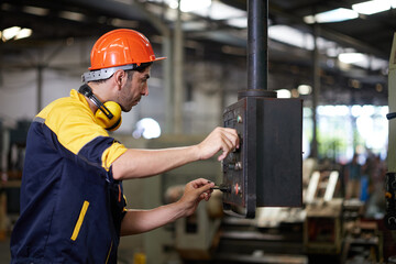 engineer or technician checking lathe machine in the factory