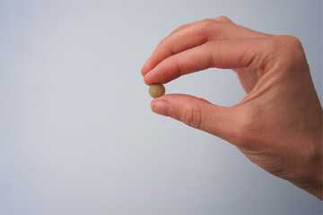 hand with pills iron