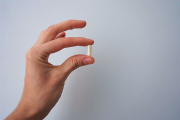 white pills in hand