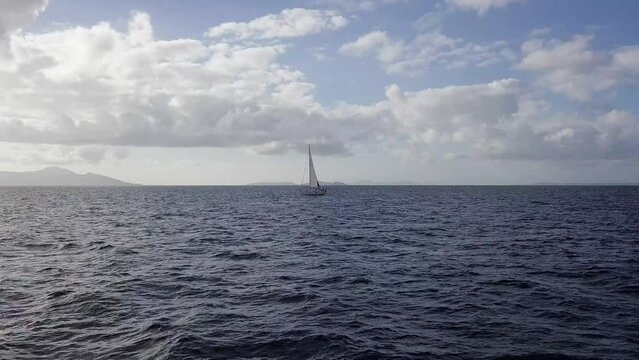 Sailing into Sunset Splendor: Breathtaking Drone Footage of a Boat on the Mediterranean, Gliding Through Sunlit Waves