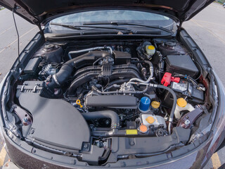 Fototapeta premium Car engine inspection before purchase. Pre purchase or pre delivery engine compartment check. Service in garage or shop. Certification of used car or vehicle for sale, trade in or financing.