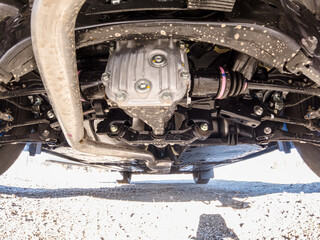 Auto mechanic view of bottom of the car. Rear differential axle wide angle, rear suspension system...