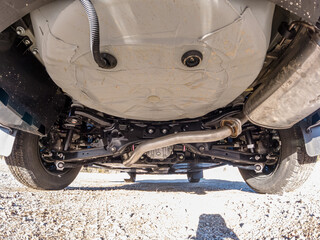 Auto mechanic view of bottom of the car. Rear differential axle wide angle, rear suspension system...