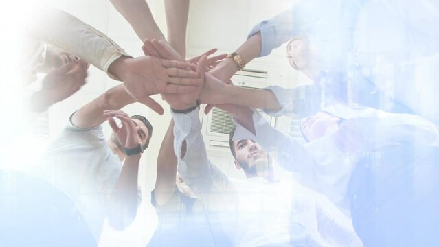 Cg footage for the background. A group of young people standing in a circle hold hands in the center of the circle. Bottom view. The concept of unification. The idea of teamwork