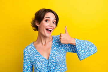 Portrait of satisfied ecstatic girl with short hairstyle wear blue blouse show thumb up good work...