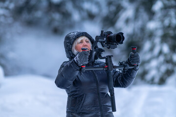 Lady takes video of winter forest