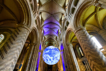 Interior view of the Norman style Durham Cathedral with the detailed 3 dimensional Earth replica hanging inside, in Durham, England, UK. - obrazy, fototapety, plakaty