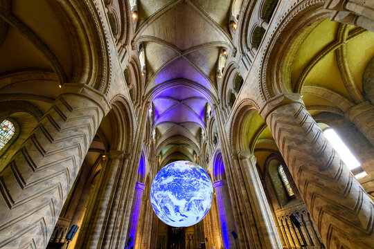 Interior view of the Norman style Durham Cathedral with the detailed 3 dimensional Earth replica hanging inside, in Durham, England, UK.