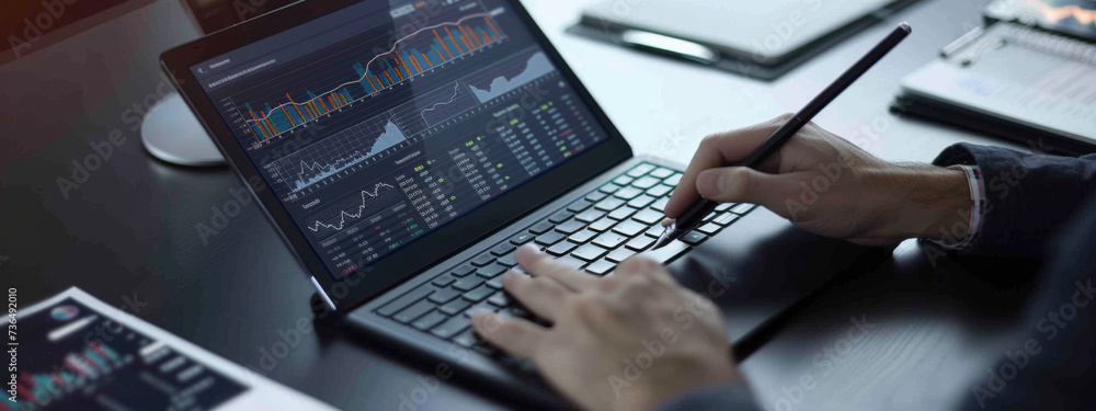 Poster an individual's hands using a stylus on a tablet with financial analysis graphs on the screen, place