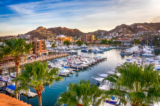 Beautiful wide view on the ocean bay and docks for pleasure vessels in golden hour. Cabo San Lucas, Baja California, Mexico