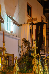 Fototapeta na wymiar semana santa de Sevilla, paso alegórico del triunfo de santa cruz sobre la muerte, la canina 