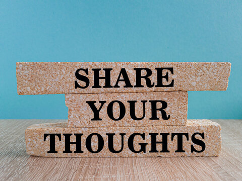 Share your thoughts symbol. Concept words Share your thoughts on beautiful brick blocks. Beautiful wooden table blue background. Business share your thoughts concept.