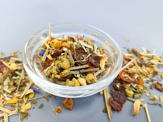 a mixture of herbs and tea flowers in a saucer