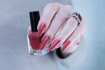 Female hands with long nails and dark red nail polish