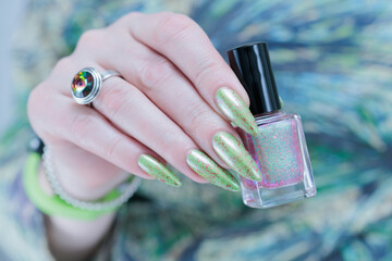 Female hand with long nails and light green manicure