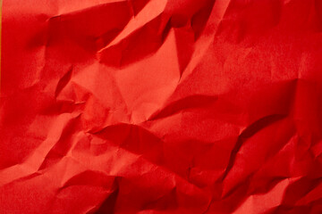 Red crumpled paper as a background.
