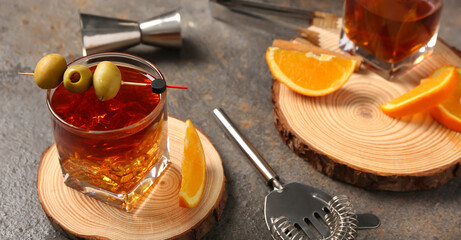Glass of cold Old Fashioned Cocktail on grunge background