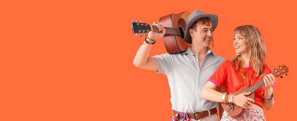 Couple of hippies playing guitars on orange background with space for text