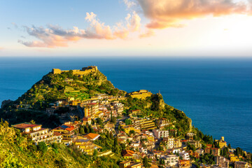 scenic view at beautiful mountain town on a sea coast in Italy with green hills, antique buildings...