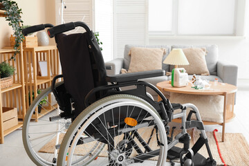 Modern empty wheelchair in living room near beige wall