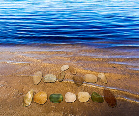 Zodiac sign  Libra laid out from small stones on the shore