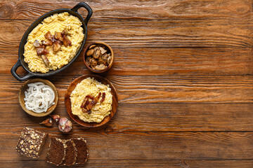 Tasty banosh and ingredients on wooden background