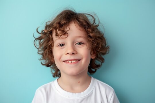 Portrait of 10 years old boy with beautiful face on blue background