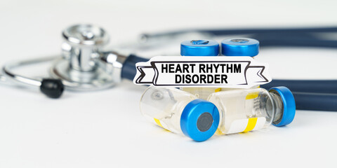 On the table there is a stethoscope, injections and a sign with the inscription - heart rhythm...