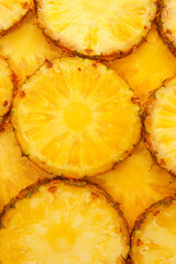 Pineapple juicy yellow slices as a background.