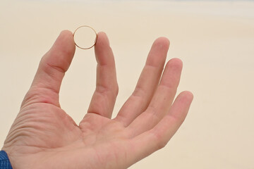 a ring for the bride in the man's hand. close-up