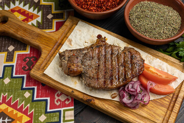 Georgian meat dishes on a dark wooden table 