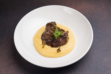 Delicious baked veal cheeks on a plate