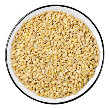 Top view of raw pearl barley in a bowl isolated on white